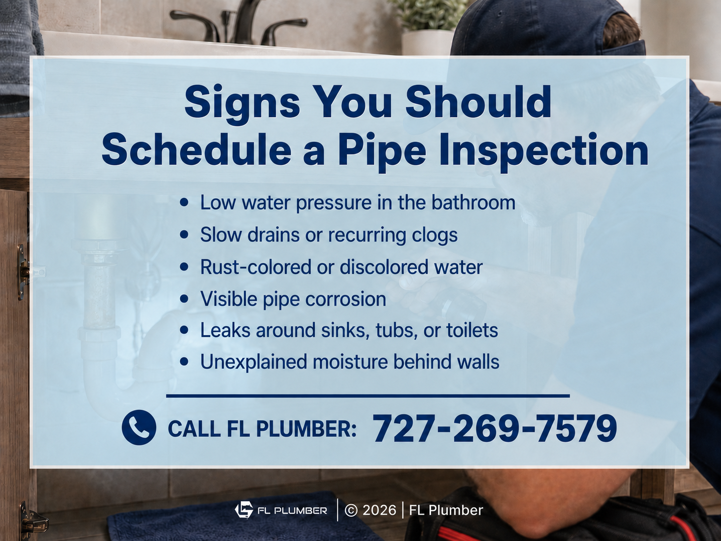 A technician works under a bathroom sink examining plumbing components and pipe connections inside a vanity cabinet.